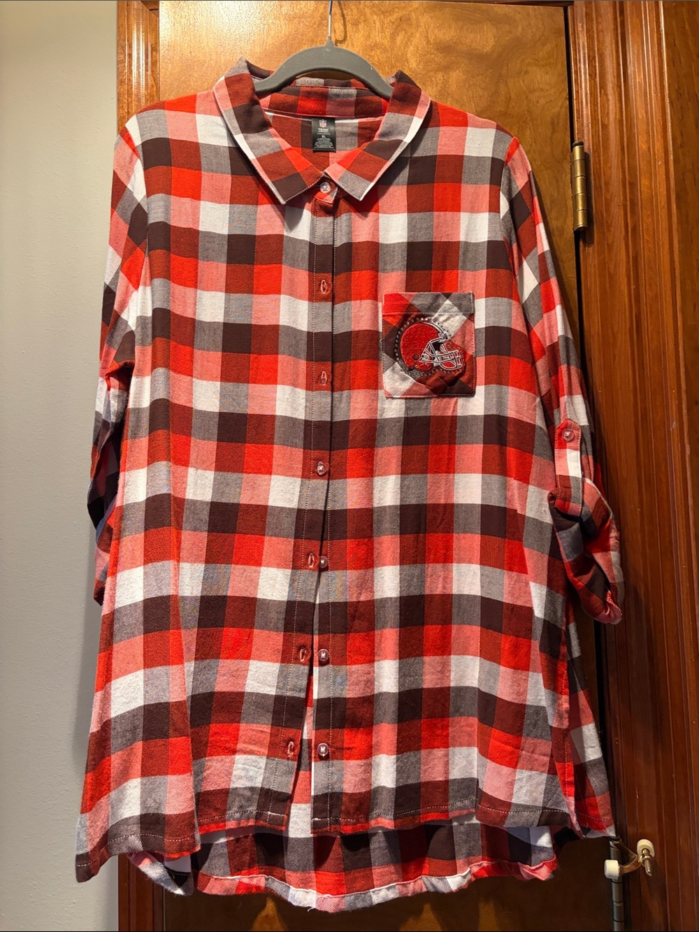 Women’s NFL Cleveland Browns button shirt with collar and roll tab sleeves.